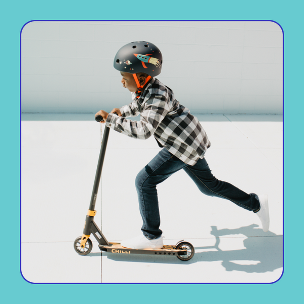 A boy is focused while riding the Corey Funk Signature Chilli Scooter.