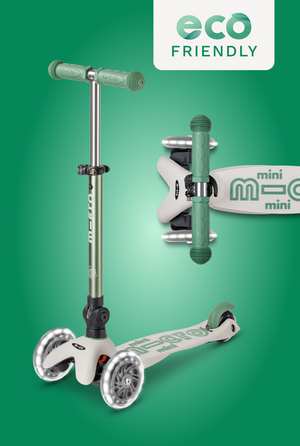 Micro mini scooter with a silver deck and green handlebars on a green background, featuring the 'eco friendly' label.