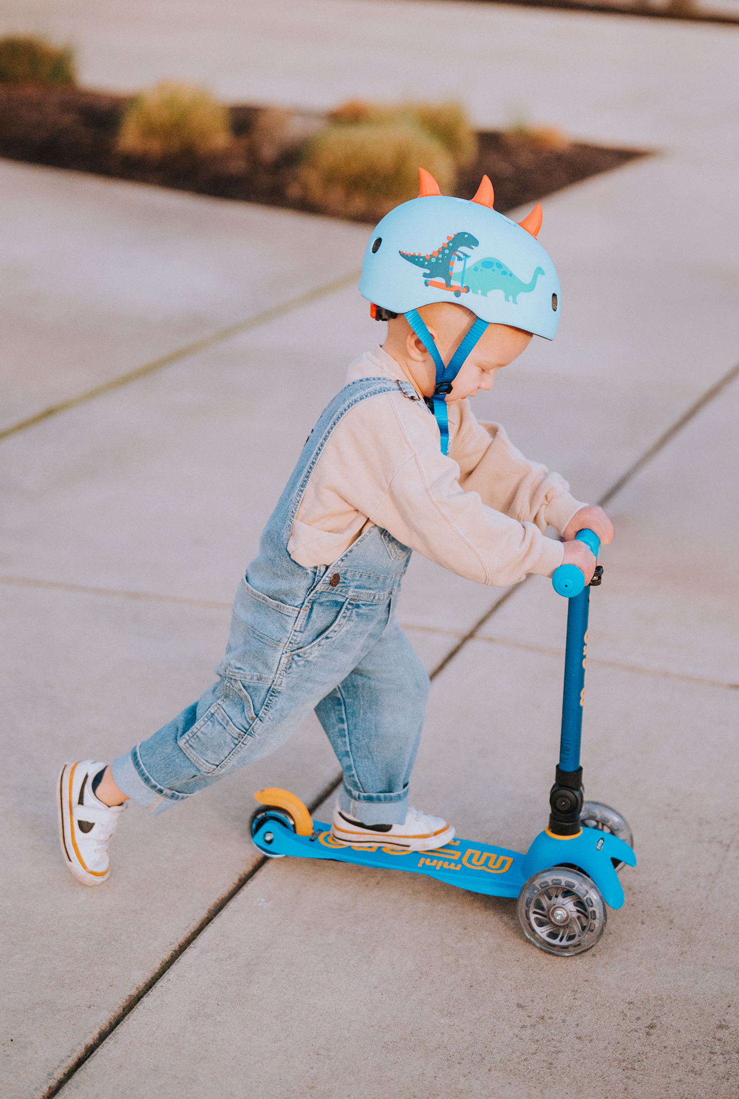 A young boy riding his Mini Foldable LED scooter.