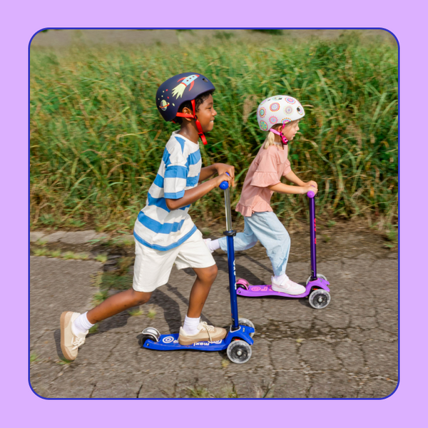 Two kids ride side-by-side on their Micro Maxi LED Scooters. 