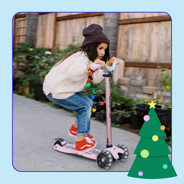 A girl squats down slightly while riding her Micro Maxi Pro LED Scooter for an exciting ride. 