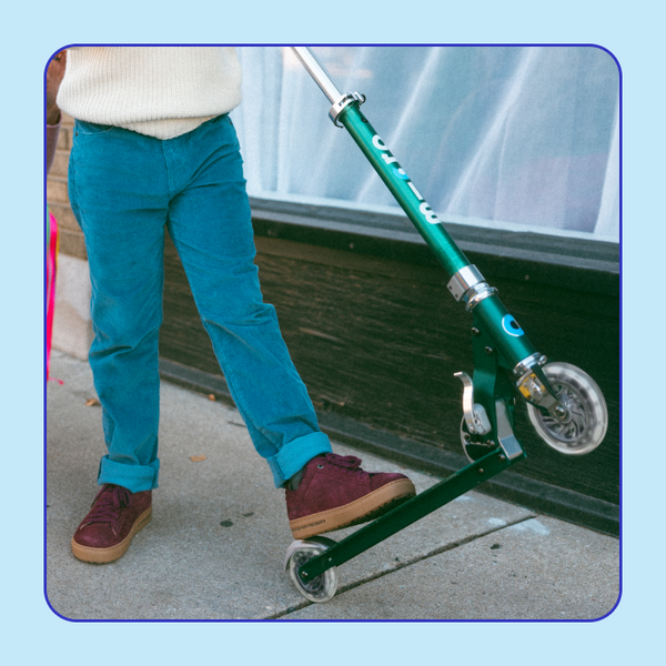 A closeup of the Micro Sprite LED Scooter in the Forest Green color. 